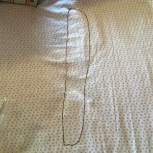 Gold tone “love knot” chain